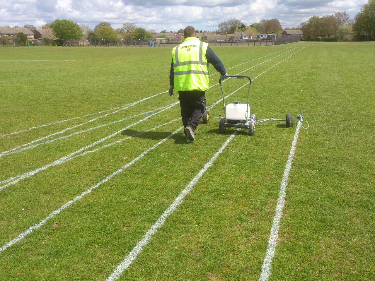 Green Scythe operative line marking a running track on a school field